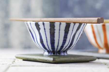 bowl and chopsticks on a wooden table, shallow dof.の写真素材