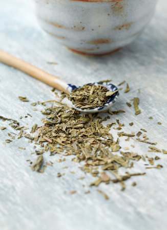 Dried oregano on a wooden spoon, selective focus.の写真素材
