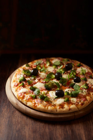 pizza with olives and basil on wooden tableの写真素材