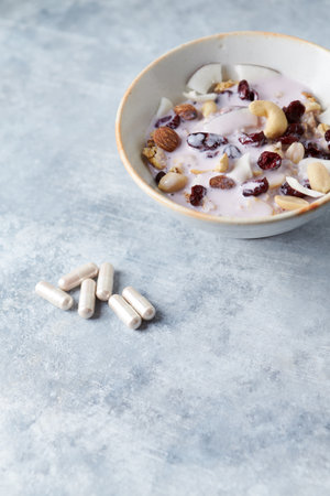Oatmeal with nuts and raisins in a bowl on the tableの写真素材