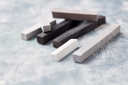 Wooden chalks on a blue background. Selective focus.の写真素材