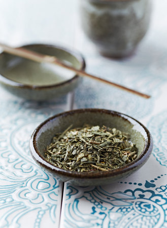 Green tea in a bowl with chopsticksの写真素材