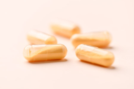 Close up of yellow pills on white background. Focus on foreground.の写真素材