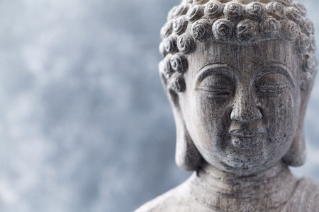 Buddha statue with copy space on gray background, close upの写真素材