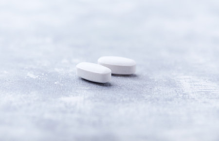 Amino acids tablets on wooden background. Soft focus. Close-up