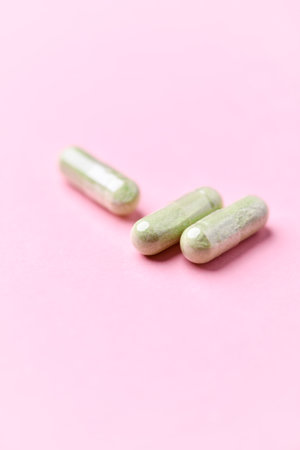 Pills on a pink background. Focus on foreground, soft bokeh.の写真素材