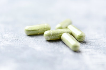 Herbal medicine capsules on light background. Selective focus with shallow depth of field.の写真素材