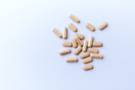 Pills on a blue background. Focus on foreground, soft bokeh.の写真素材