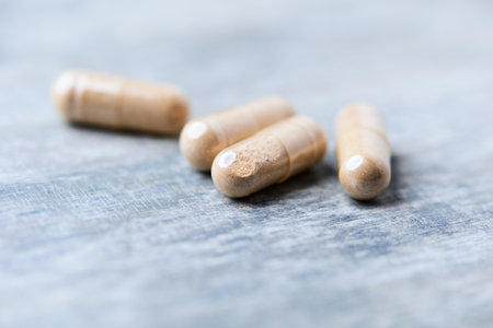Pills on wooden background. Focus on foreground, shallow DOF.