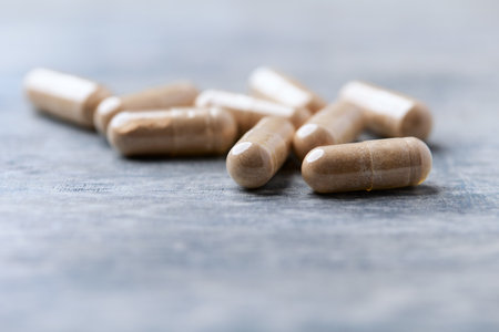 Pills on blue wooden table. Focus on foreground, shallow DOF.の写真素材