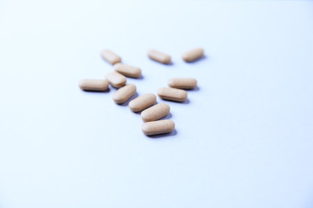 Close up of pills on white background. Focus on foreground, soft bokeh.の写真素材