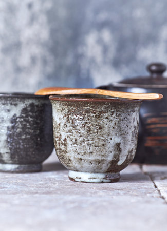 Traditional japanese clay pottery and utensils on wooden backgroundの写真素材
