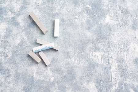 Pieces of chalk on a gray concrete background. Copyspace.の写真素材