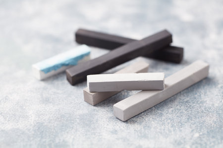 Pile of black and white chalk on light background, closeupの写真素材