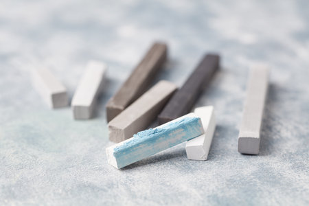 Colored chalks on a blue background. Close up.の写真素材