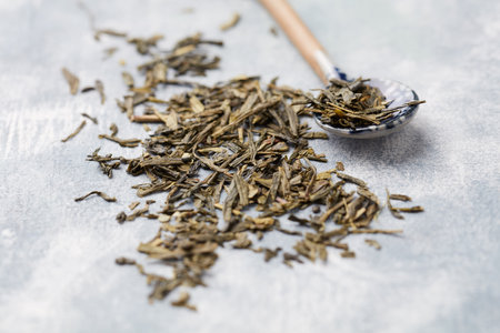 Dry tea leaves on a wooden spoon. Selective focus.の写真素材