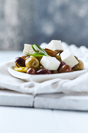 Greek olives with feta cheese and olive oil in a plateの写真素材