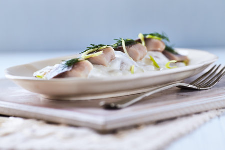 Salted herring salad with mayonnaise and dill, selective focus