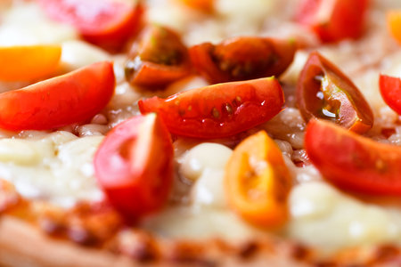Pizza with mozzarella cheese and tomatoes, close-upの写真素材