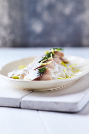 Herring fillet with cream sauce and dill, selective focusの写真素材