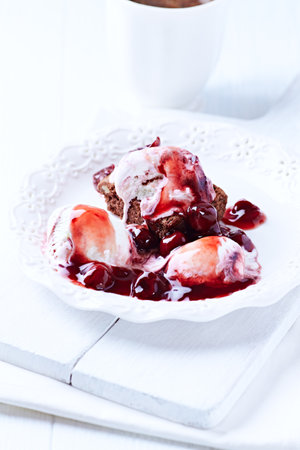 Cottage cheese pancakes with berry sauce and ice cream. Shallow doof.の写真素材
