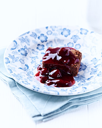 Chocolate brownie with cherry syrup. Selective focus. Copy space.の写真素材