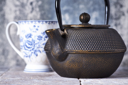 Teapot and cup of tea on wooden table. Selective focusの写真素材