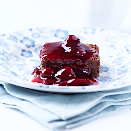 chocolate cake with cherry jam on a white background. tinting. selective focusの写真素材