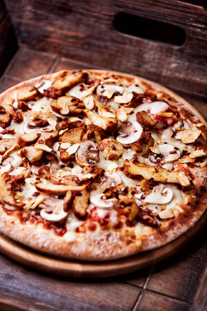 pizza with mushrooms on a wooden background. tinting. selective focusの写真素材