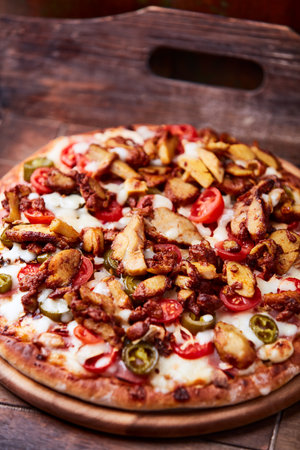 Pizza with bacon and vegetables on a wooden table, selective focus.の写真素材