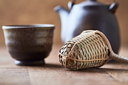 teapot and cup of tea on wooden table, closeup