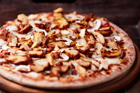 pizza with mushrooms and cheese on a wooden background. tinting. selective focusの写真素材