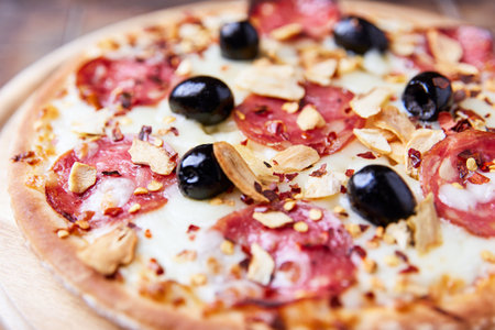 Pizza with salami, olives and mozzarella cheeseの写真素材