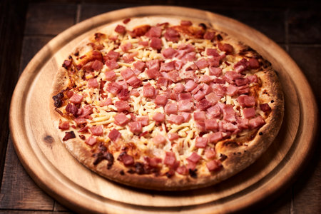 Pizza with ham and cheese on a wooden table. Selective focus.の写真素材
