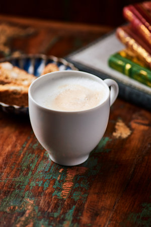 Cup of cappuccino on a wooden table, selective focusの写真素材