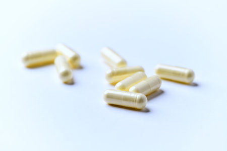 Capsules on white background. Focus on foreground, soft bokeh.の写真素材
