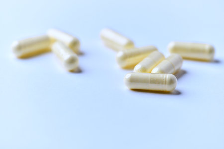 Capsules of yellow color on a white background close-up