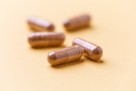 Close up of omega 3 capsules on yellow background with copy space.の写真素材