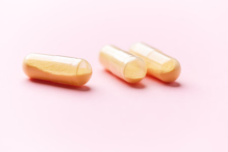 Capsules of omega 3 fish oil on a pink background.