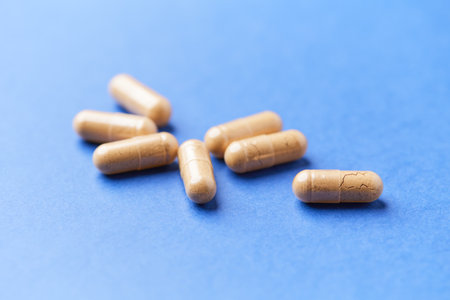 Capsules of medicine on a blue background. Close up.