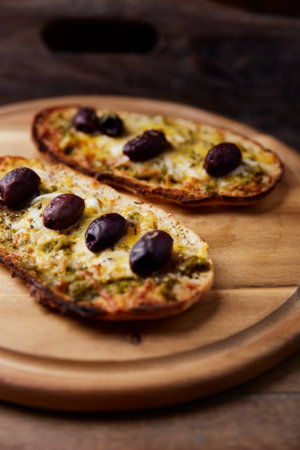 Tasty bruschetta with olives and mozzarella