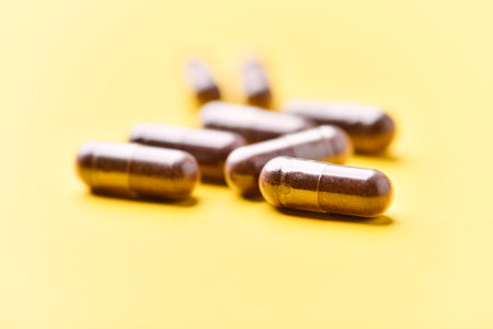 Pills on a yellow background. Focus on foreground, soft bokeh.の写真素材