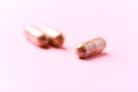 Two bullets on a pink background. Shallow depth of field.の写真素材