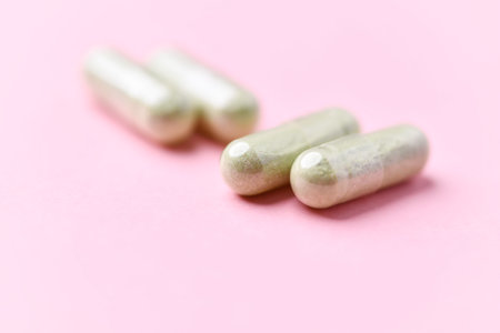 Capsules of medicine on a pink background. Close-up.の写真素材