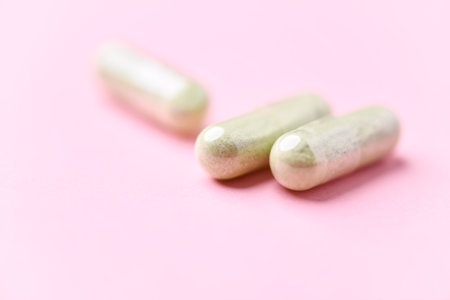 Capsules of medicine on a pink background. Close up.の写真素材