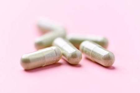 Capsules of medicine on a pink background close-up.の写真素材