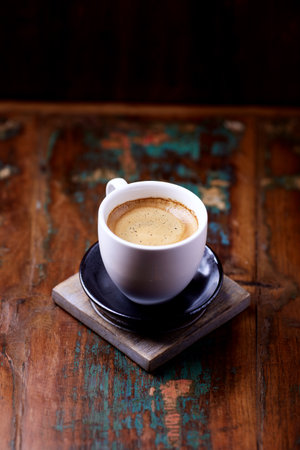 Coffee cup on old wooden table. Selective focus.の写真素材