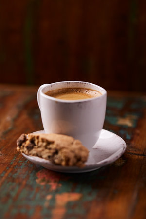 Coffee cup and cookies on old wooden table, selective focusの写真素材