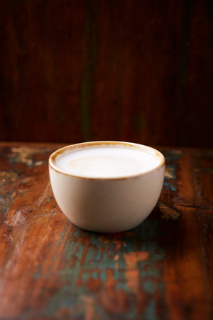 Coffee cup on old wooden table, vintage style, selective focusの写真素材