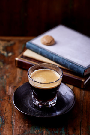 Coffee in a glass on a dark wooden background. Selective focus.の写真素材